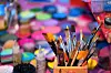 Paintbrushes over a colorful background