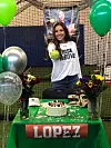 Edyn-Lopez-Poses-with-a-softball